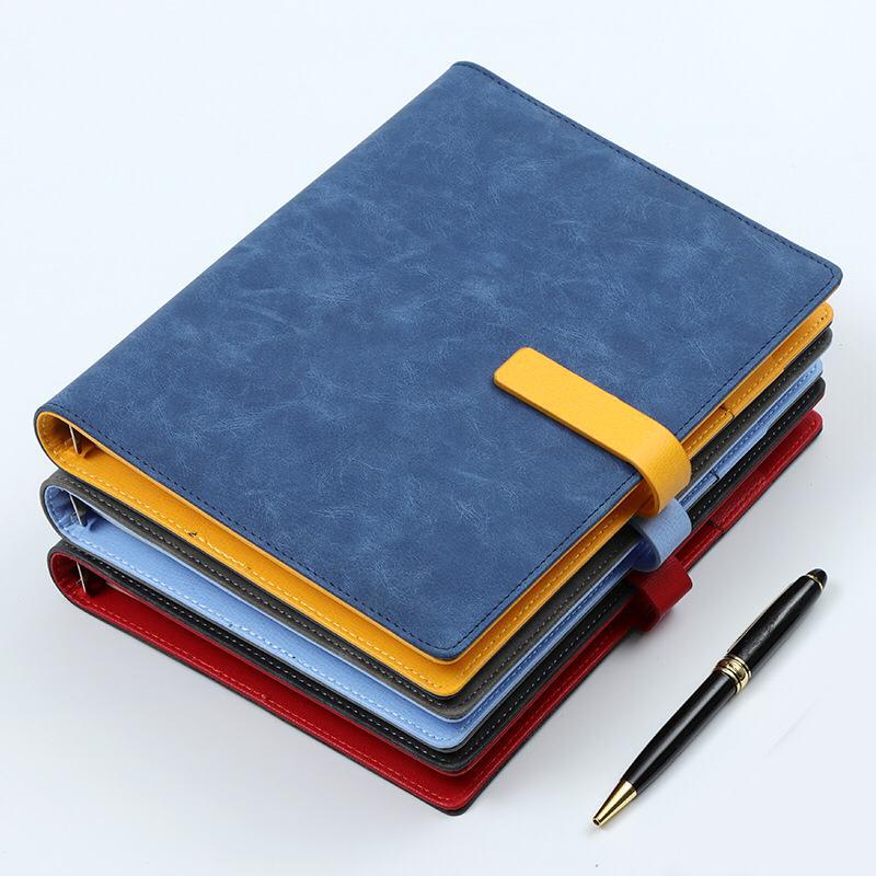 Notebooks and writing accessories in example colours