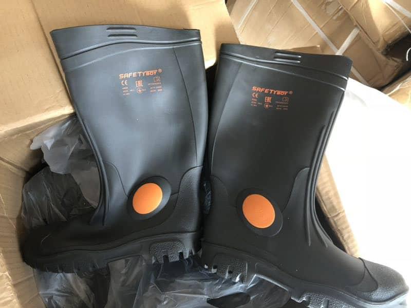 Black protective work boots displayed on a counter