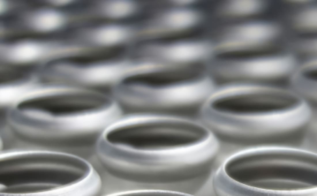 Rows of deep-drawn aluminum canisters in production