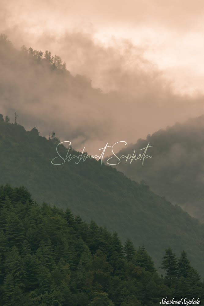 Monsoon mist rolling over the forested hills of Nepal