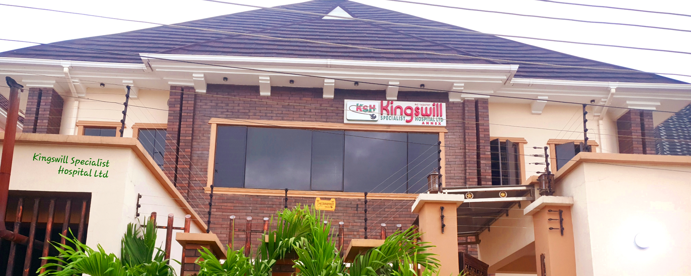 Exterior view of Kingswill Specialist Hospital building at Diamond Estate, Lagos — a modern medical facility with signage