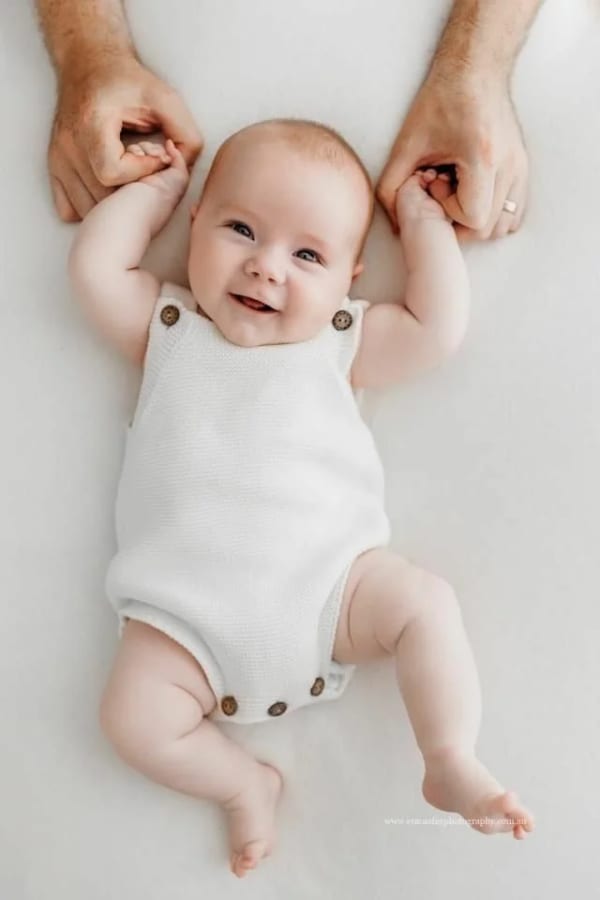 Newborn holding a hands of an adult. — AI image prompt example