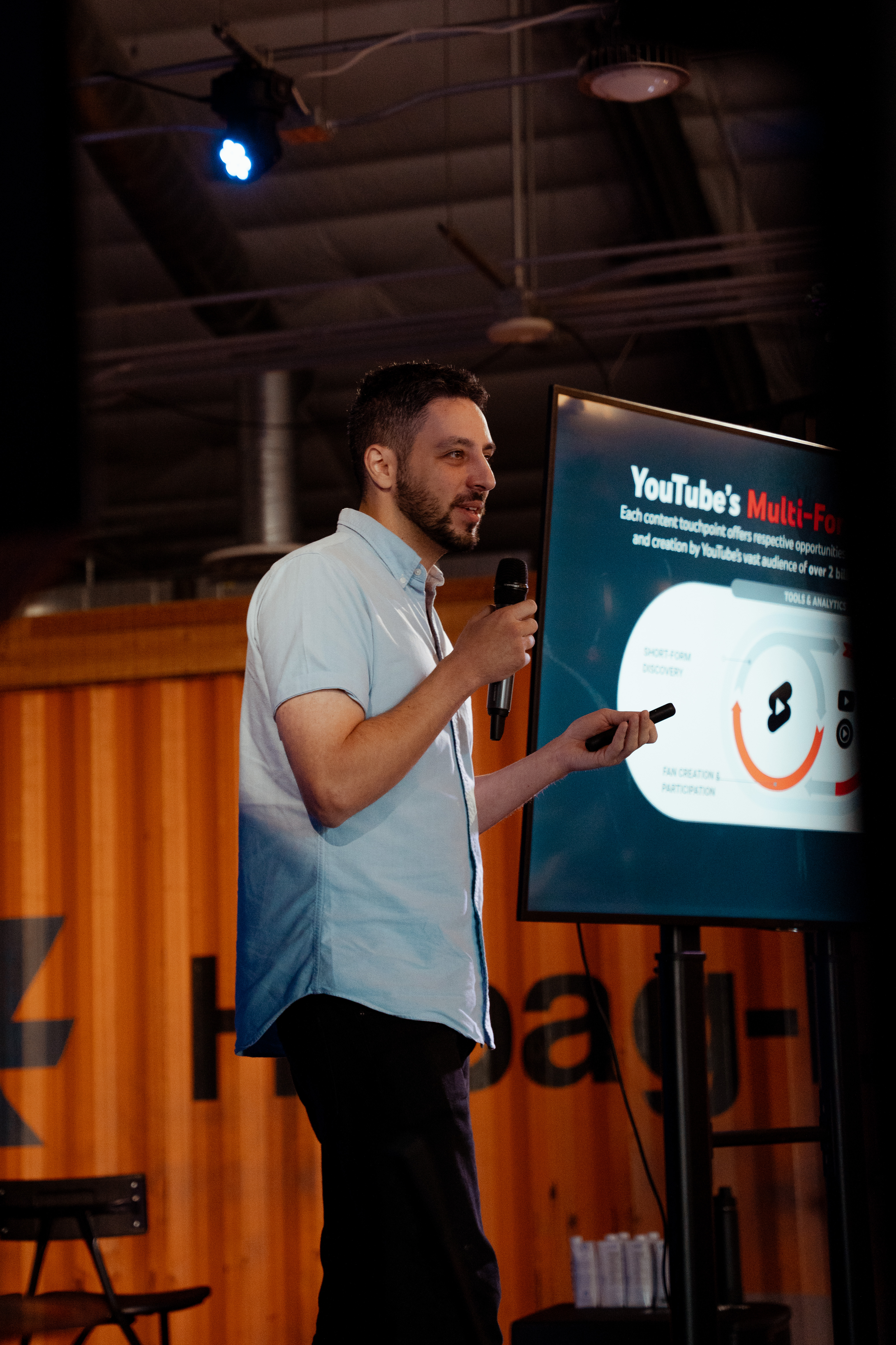 Speaker on couch at Imagiin event sharing insights and engaging with audience.