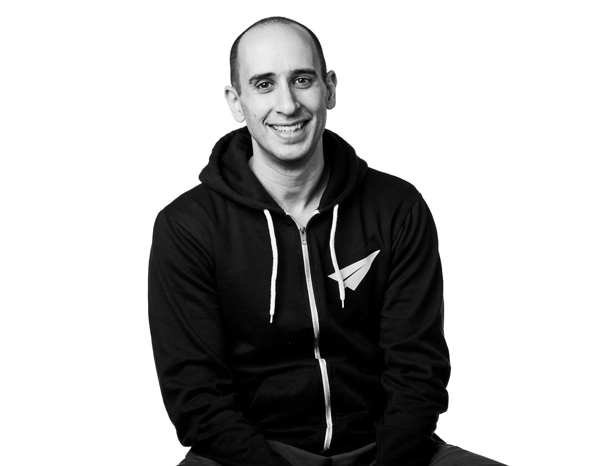 Black and white portrait of man with warm smile.