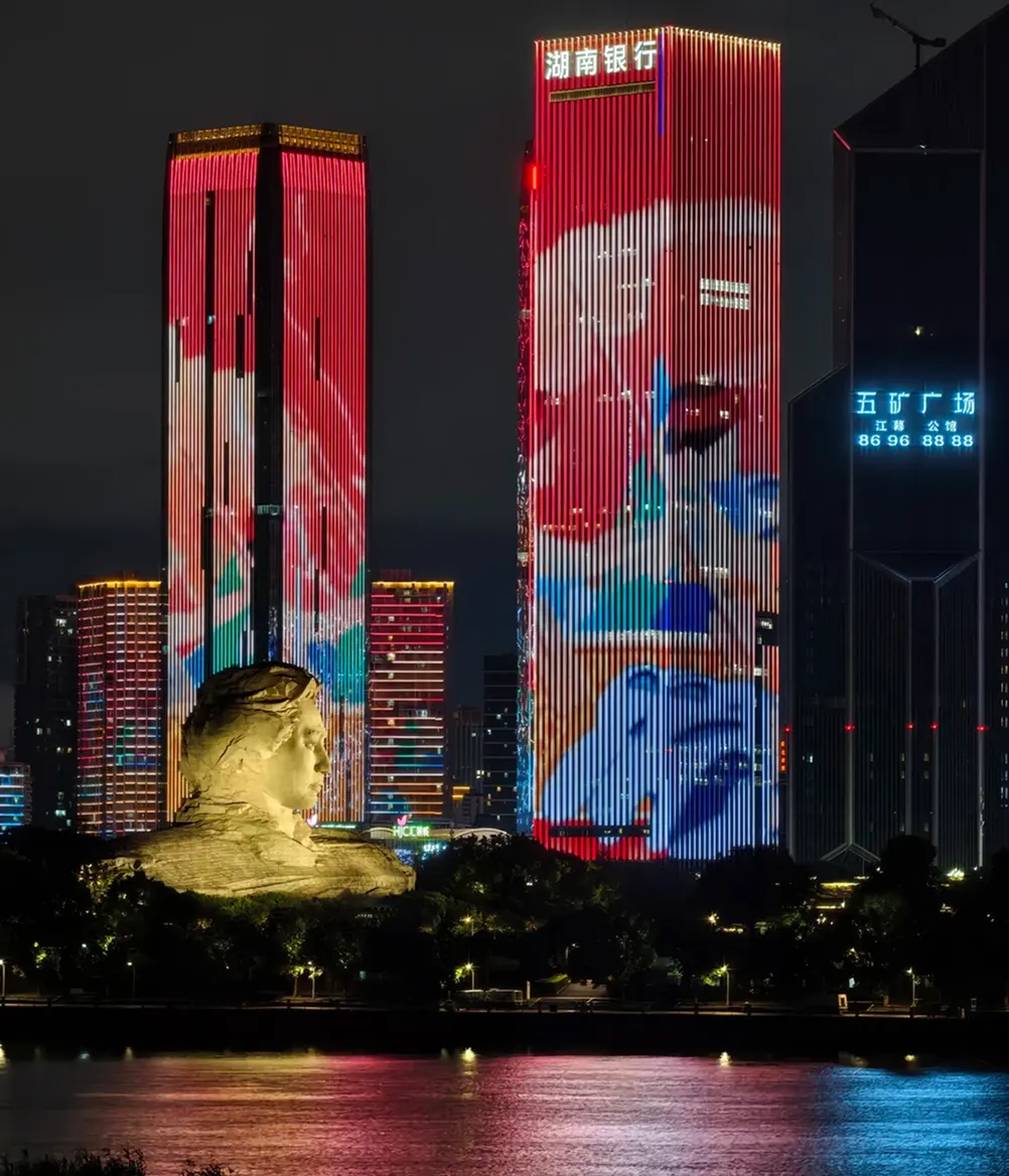 Red lights on riverside buildings